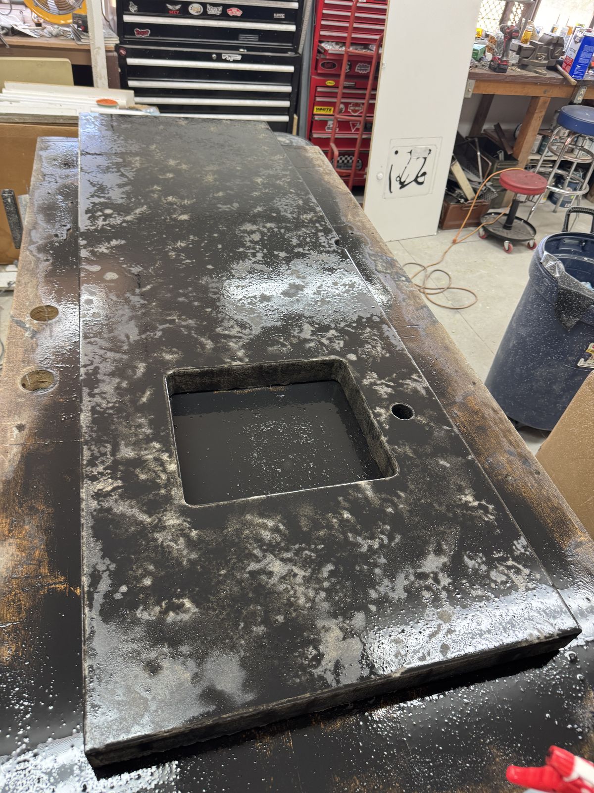 Building up the concrete finish: a mottled black base coat.