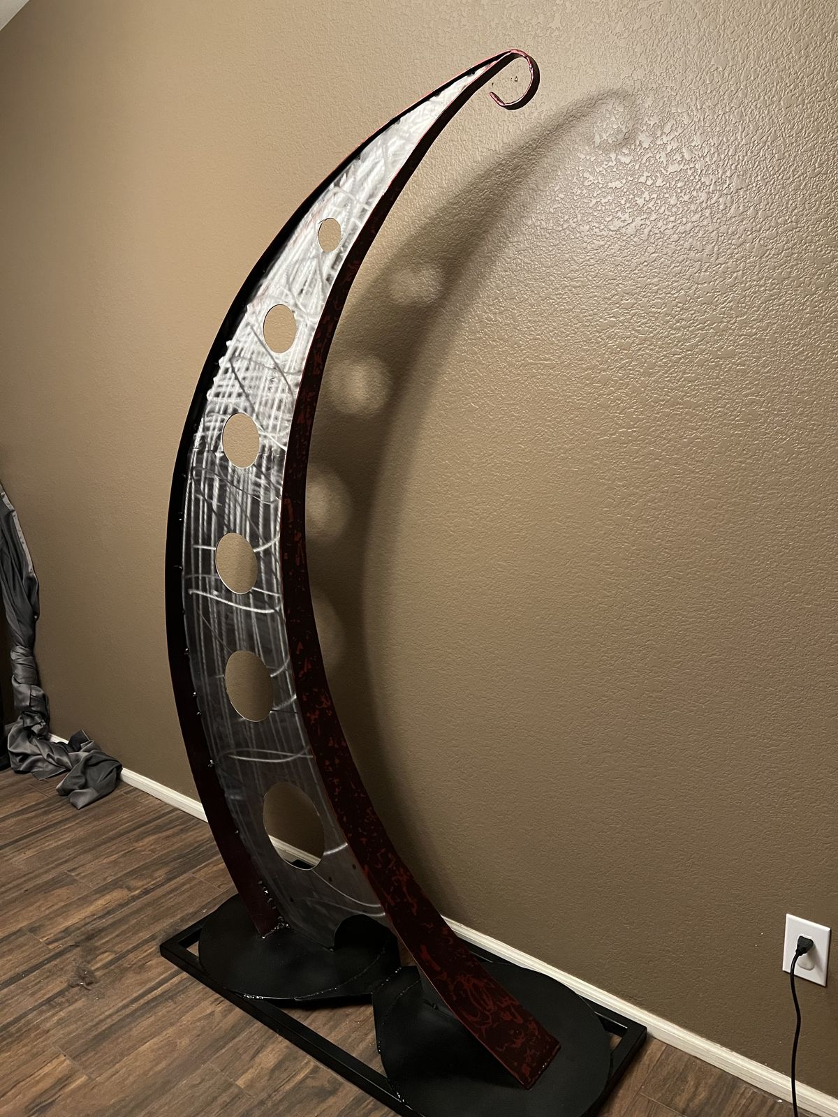 Crescent frame standing on its steel base, ready to hang the clock.